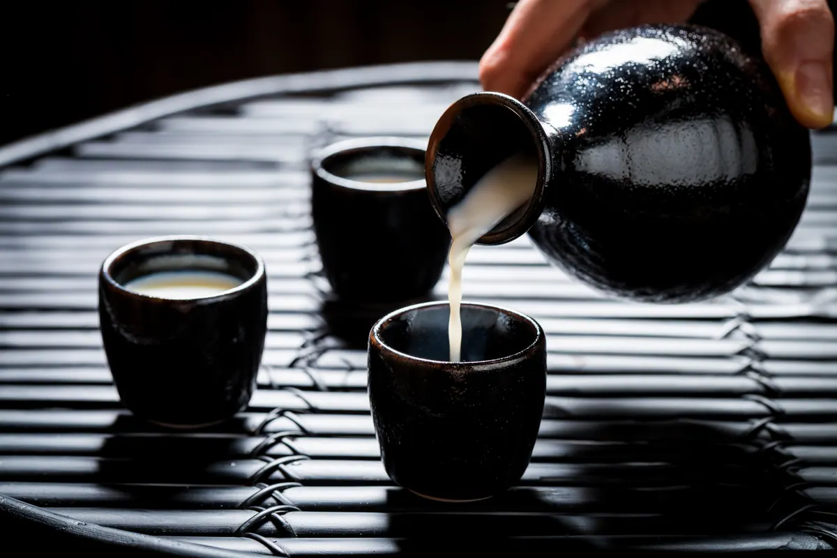 Sake poured into a small glass at the counter